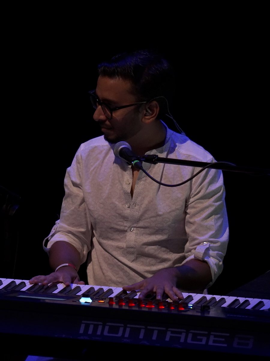 Tushar Lall playing keys on stage
